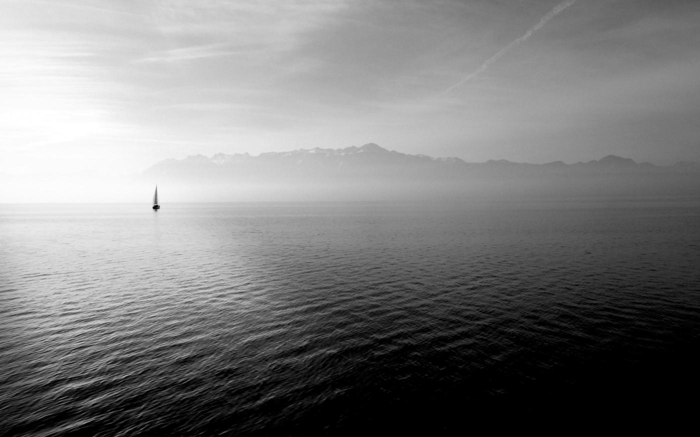 sailboat on calm body of water under white sky at daytime by Hugo Kerr courtesy of Unsplash.