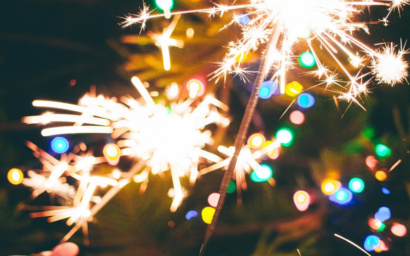 a person is holding a sparkler in their hand by Marisol Benitez courtesy of Unsplash.