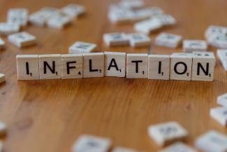 Inflation is spelled out using scrabble tiles. by Markus Winkler courtesy of Unsplash.