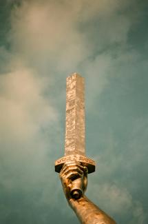 A statue of a hand holding a tall object by Valeria Kodra courtesy of Unsplash.
