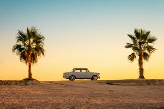 white and black car on brown sand during daytime by Mateo Giraud courtesy of Unsplash.