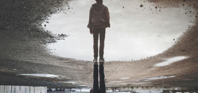 man's reflection on body of water photography by Randy Jacob courtesy of Unsplash.