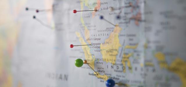 world map with pins by Z courtesy of Unsplash.