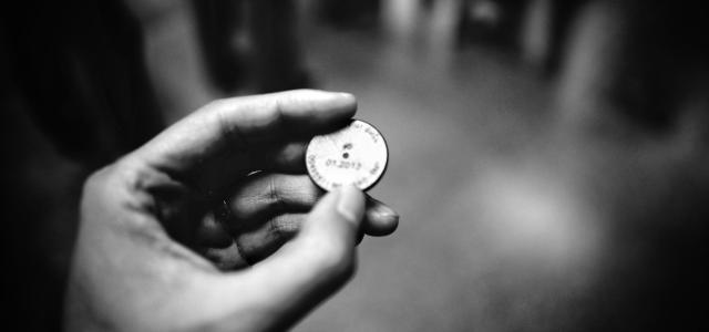 grayscale photography of person holding coin by ZSun Fu courtesy of Unsplash.